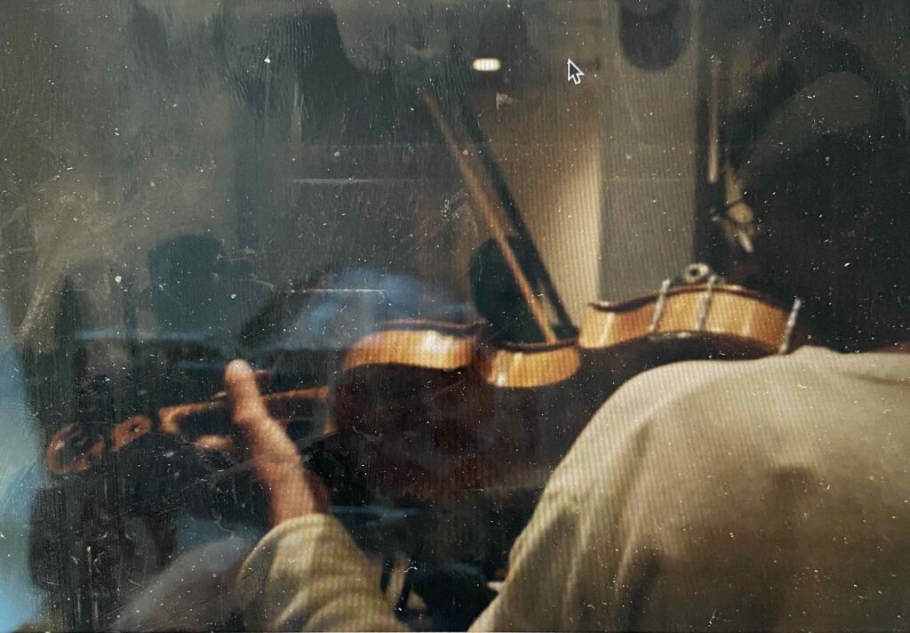 Playing the violin or fiddle.