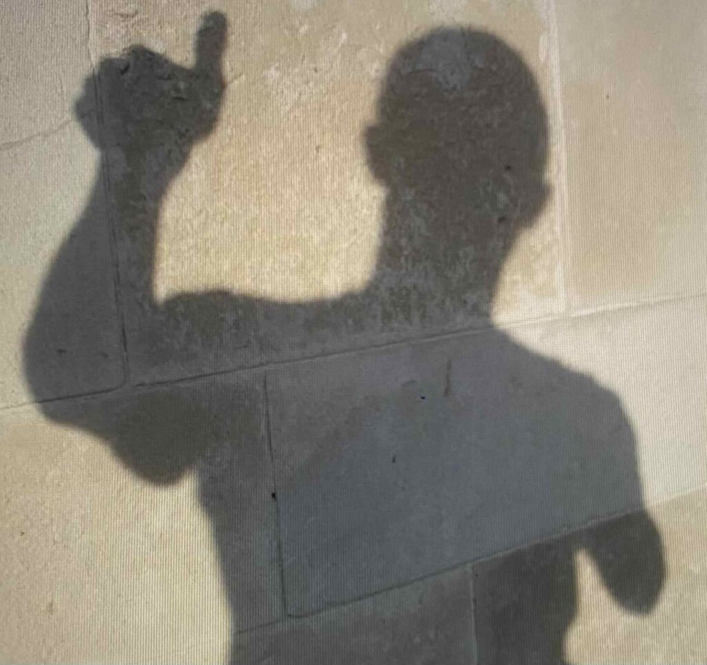 Silhouette of a man raising his thumb up to express approval.