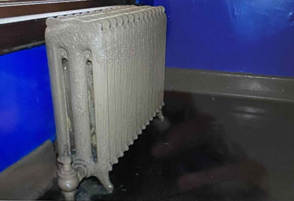A radiator below a window.