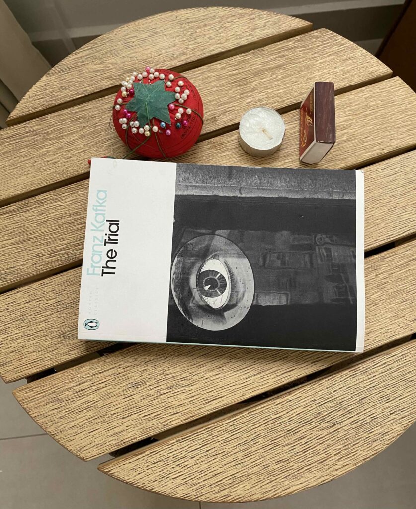 Things on Fraulein Burstner's bedside table - a candle, a box of matches, pin cushion & a book.