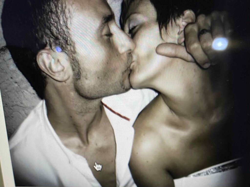 Man & woman kissing.